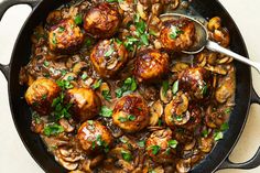 a skillet filled with meat and mushrooms