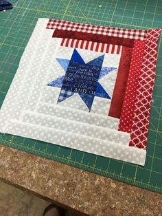 a close up of a quilt on a cutting board