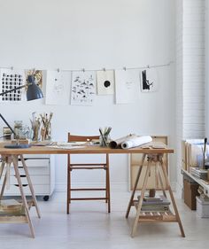 an artist's studio with art supplies on the table