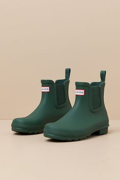 Romanticize rainy days with every step in the Hunter Original Hunter Green Chelsea Rain Boots! These matte rubber rain boots feature a rounded upper that rises to an ankle-high shaft with elastic gussets at the instep and outstep. The slip-on design features a pull tab and a ribbed-textured detail at the back, all atop a sturdy low-block heel. Logo tag at the front. Available in whole sizes only. 0. 75" rubber heel. Lightly cushioned insole. Rubber sole has nonskid markings. Man made materials. Short Rain Boots, Chelsea Rain Boots, The Hunter, Low Block Heels, Logo Tag, Heel Boots, Rubber Heels, Hunter Green, High Heel Boots