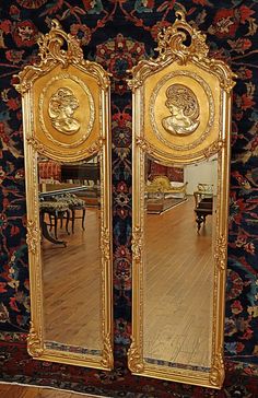 two large mirrors sitting on top of a wooden floor