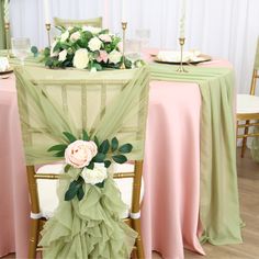 the table is set with pink and green linens