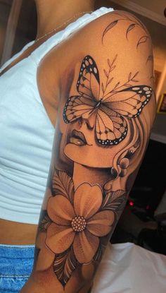 a woman's arm with a butterfly and flower tattoo on the left side of her body