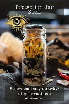 a jar filled with yellow flowers sitting on top of a wooden table next to other items