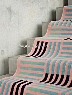 a striped rug is sitting on the stairs