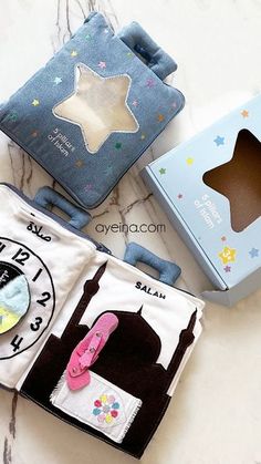 three baby items are sitting on the table together, including a book and an alarm clock