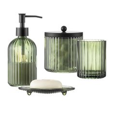 green glass bathroom accessories including soap dispenser, soap dish and toothbrush holder