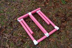 a pink and white frame laying on the ground