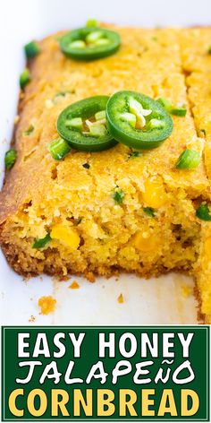 a close up of a cornbread on a plate with green onions and jalapenos