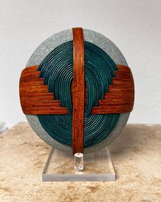 a blue and brown object sitting on top of a marble table next to a white wall