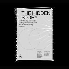 the hidden story book cover with two circles in front of it on a black background