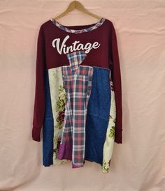 "Upcycled sweatshirt tunic, long sleeved, size UK22/EU 50/USA 20 Width at underarm/top of \"skirt\" of tunic 48\"/122cm. This part of the garment is made of woven fabrics, so won't stretch. Flares out from this point so width at hipline is around 57\"/144cm Uneven hem; shortest length at back is 35\"/89cm Top of tunic is an upcycled sweatshirt; \"skirt\" of tunic is made from woven fabrics - upcycled shirts, denim and household linens. Wash at 30 degrees; tumble dry at appropriate temperature. N Oversized Bohemian Patchwork Tops, Oversized Hippie Tops For Fall, Fall Bohemian Tops For Loungewear, Free-spirited Cotton Tops For Fall, Fall Cotton Free-spirited Tops, Oversized Long Sleeve Patchwork Sweatshirt, Bohemian Relaxed Fit Sweatshirt For Fall, Oversized Long Sleeve Tunic For Fall, Oversized Patchwork Tops For Fall