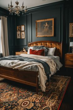 a bedroom with black walls and an antique style bed frame, chandelier, rug, and painting on the wall