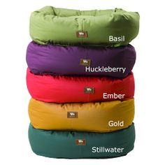 four bean bag pillows stacked on top of each other with the words, huckleberry ember gold stillwater