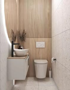 a white toilet sitting next to a sink in a bathroom under a wooden paneled wall