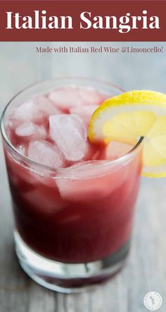 a red wine and lemon cocktail in a glass with ice on the rim that reads italian sangria made with italian red wine & limo