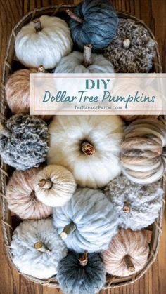 a basket filled with yarn and pumpkins on top of a wooden table