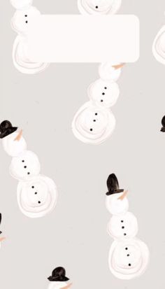 several snowmen with hats on their heads and one has a sign in the middle