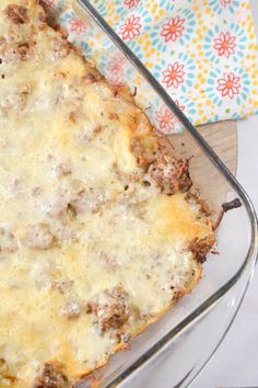 a cheesy casserole dish with meat and cheese in it on a glass platter