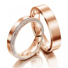 two white gold wedding rings with diamonds on each one and the other in between them