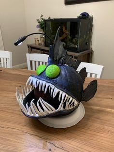 a fish mask sitting on top of a wooden table