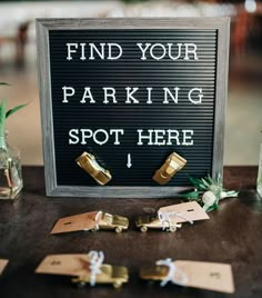 a sign that says find your parking spot here and some flowers in small vases