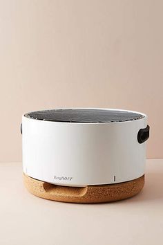 a white and black speaker sitting on top of a table