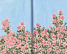 an open book with pink flowers on the pages and blue sky in the back ground