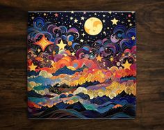 a painting on a wooden surface with stars and clouds