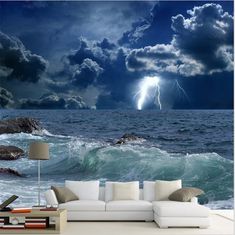 a living room scene with the ocean and clouds in the sky, as well as a couch