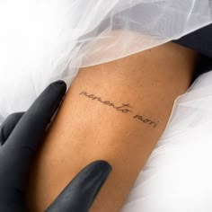 a woman with a tattoo on her arm that reads, i love you mom in cursive writing