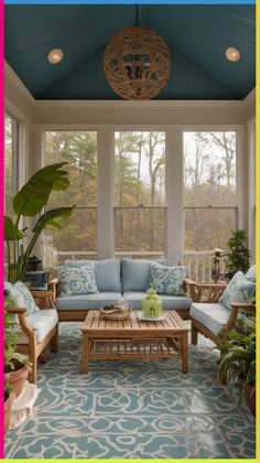 a sun room with couches, tables and potted plants