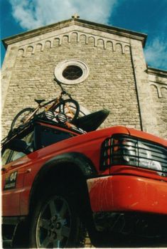 a red truck parked in front of a tall brick building