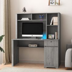 a computer desk with a monitor and keyboard