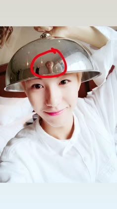 a woman wearing a chef's hat with a red circle on top of it