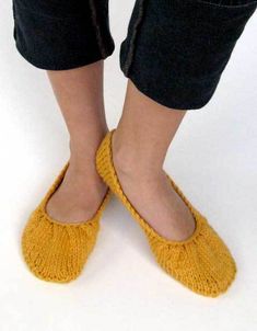 a woman's feet wearing yellow slippers