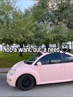 a pink car parked in front of a tree with the words not a want but a need