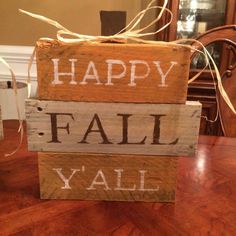 a wooden block with the words happy fall y'all written in white on it