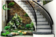 an image of a staircase going up the side of a building with plants growing on it