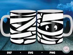 two coffee mugs with black and white designs on them, one has an eye