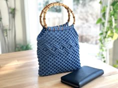 a blue purse sitting on top of a wooden table