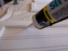 a bottle of glue sitting on top of a window sill