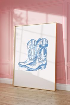 a blue drawing of cowboy boots in front of a pink wall with wood flooring