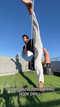 a man doing a handstand on top of a grass covered field with the caption roundhouse to spinning hook drill