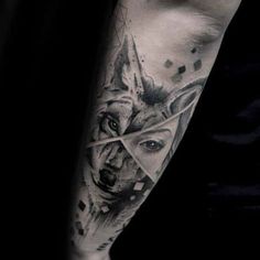 a man's arm with a wolf and triangle tattoo on the left side of his arm