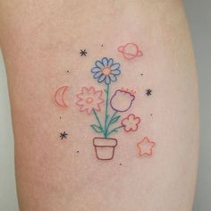 a small flower pot with flowers and stars on the side of her thigh, which is drawn in colored crayons