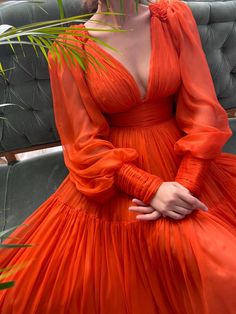 Details:-Designer silk fabric-Vivid orange color-A-line style with deep cleavage cusp and see through sleeves-For special occasions V-neck Gown With Sheer Sleeves For Evening, Orange Silk V-neck Dress, V-neck Gown With Sheer Sleeves For Party, Party Gown With Sheer Sleeves And V-neck, Elegant Orange Gown With Fitted Bodice, Orange Maxi Dress For Formal Occasions, Orange Long Dress For Evening, Orange Organza Wedding Dress, Orange Maxi Dress For Wedding