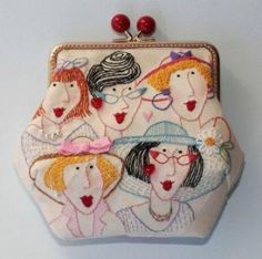 an embroidered purse with women's faces on it