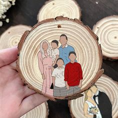 a hand holding a piece of wood with an image of people on it