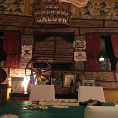 an old fashioned saloon with wooden walls and red curtains